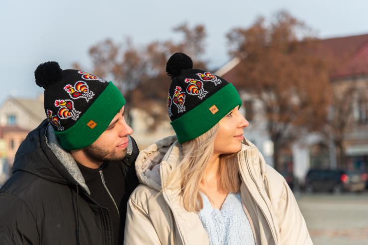 couple presenting black folk beanies with lowicz roosters pattern