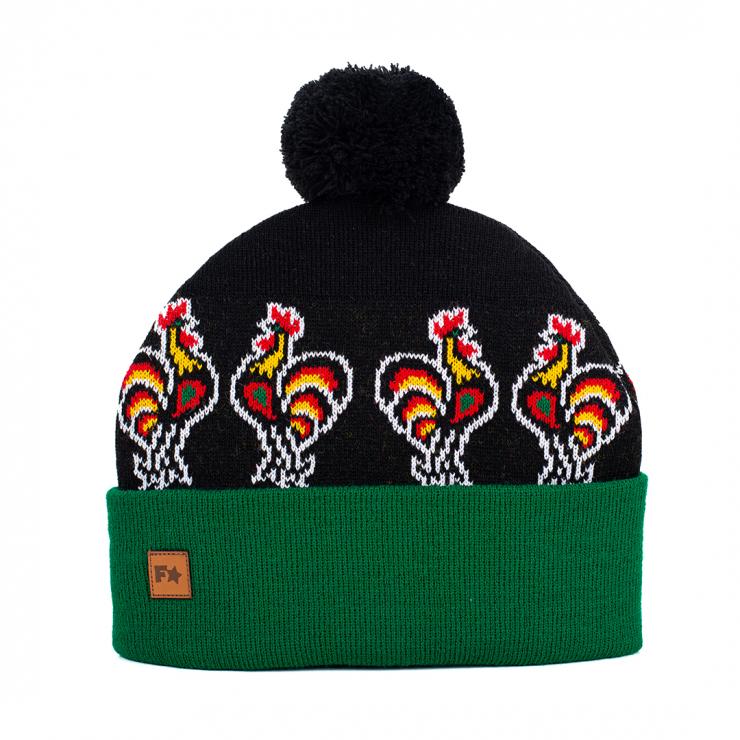 black beanie with a green ribbed brim and  roosters pattern