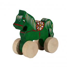 A small carved horse on wheels - green