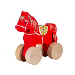 A small carved horse on wheels - red